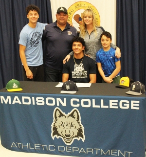 RAHS senior Edison Alonso, seated, is joined by his family as Alonso has signed on to play baseball at Madison College next year. Alonso was one of the top baseball players in the Badger Conference this past season. (Photo by Troy Matz)